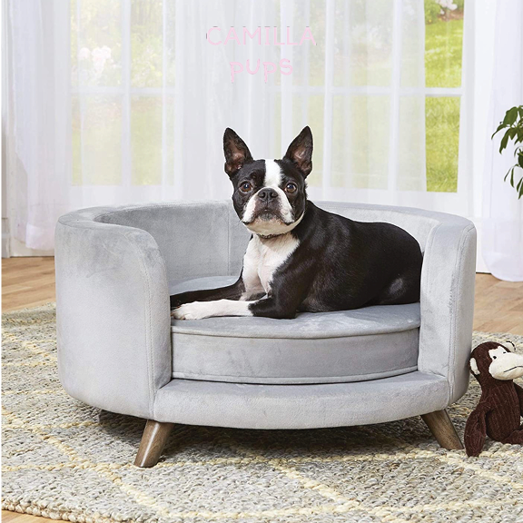 dog laying on a round sofa bed